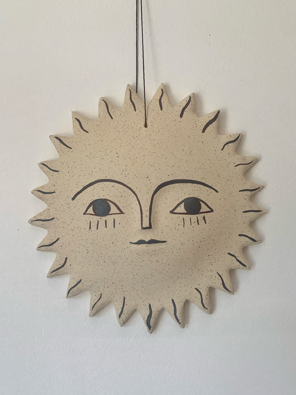 Large sun face with iron oxide stain