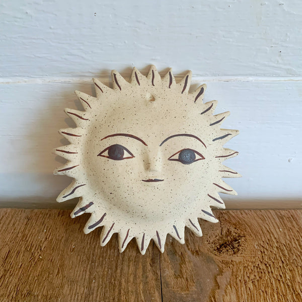 sun face with iron oxide stain