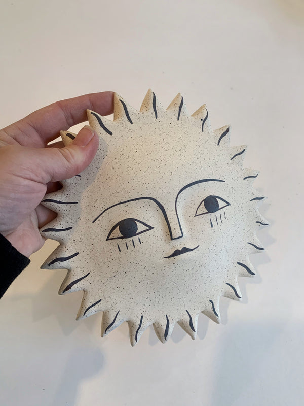 Large sun face with iron oxide stain